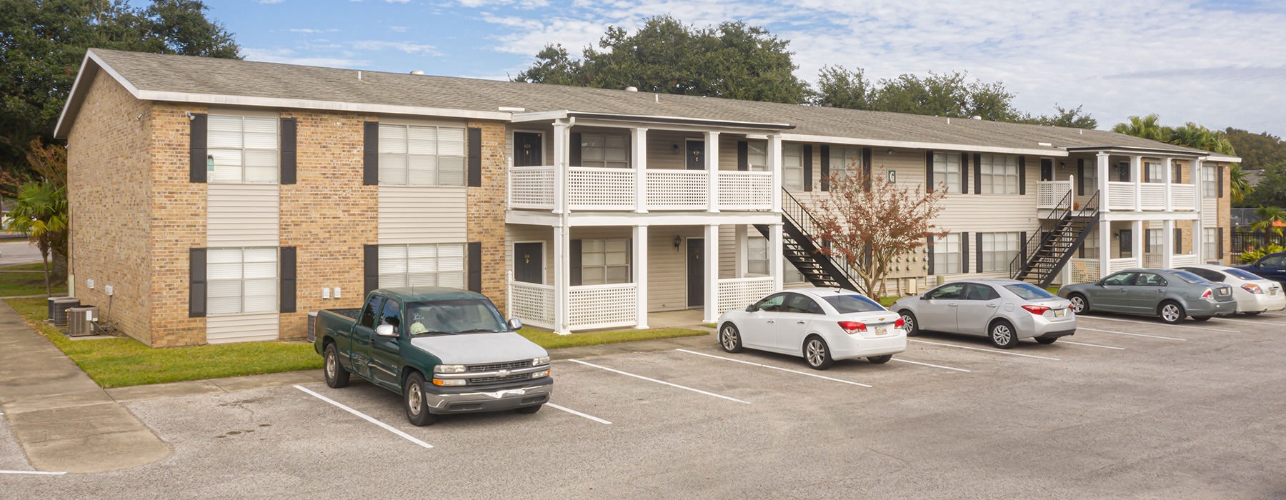 building and parking lot with cars